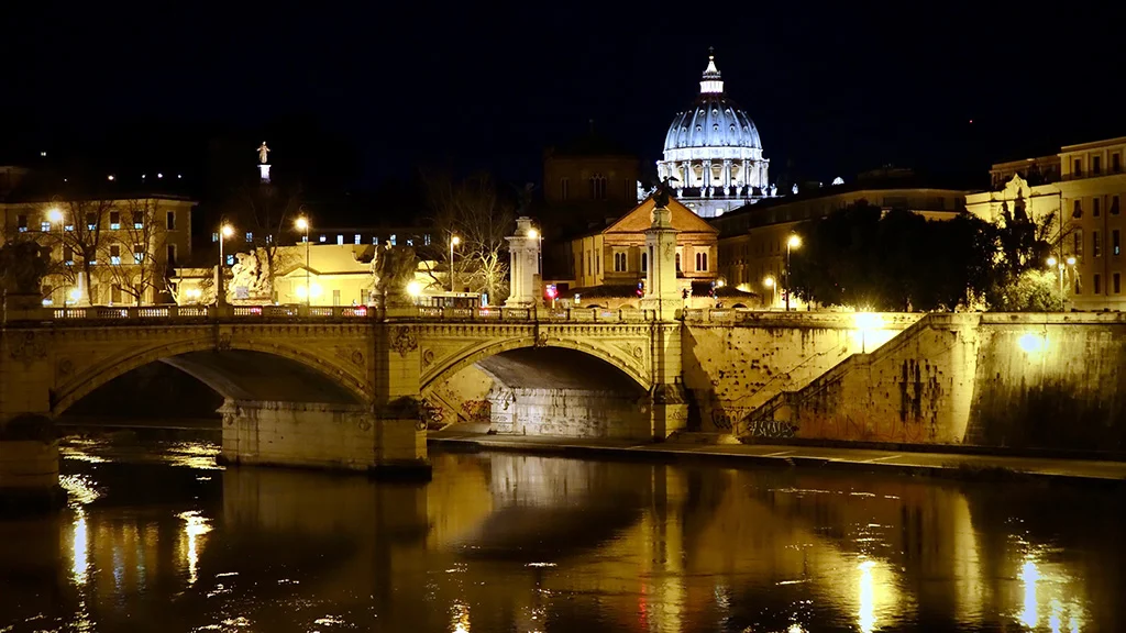 view to st. peters basilica at night, across the tiber