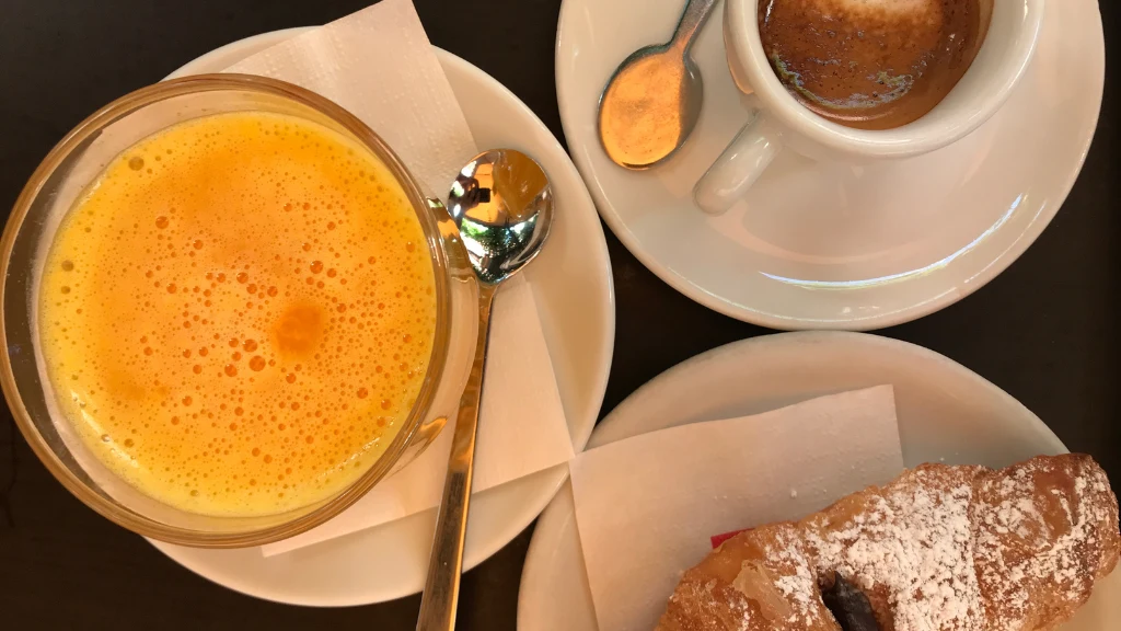 breakfast table with coffee juice and pastry