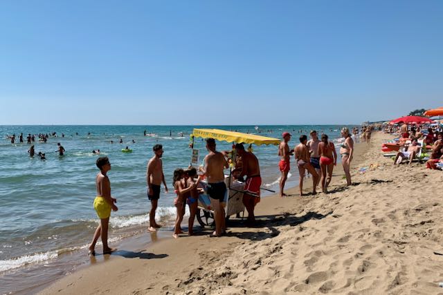 crowded beach near rome on august 15