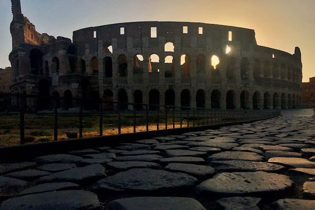 colosseum and roman road at dawn colosseum at dawn