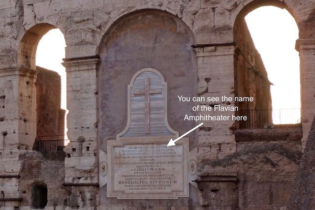 the colosseum was initially called the "Flavian Amphitheater" after its founder of the Flavian Dynasty. a sign on the colosseum wall naming the "flavian amphitheater"