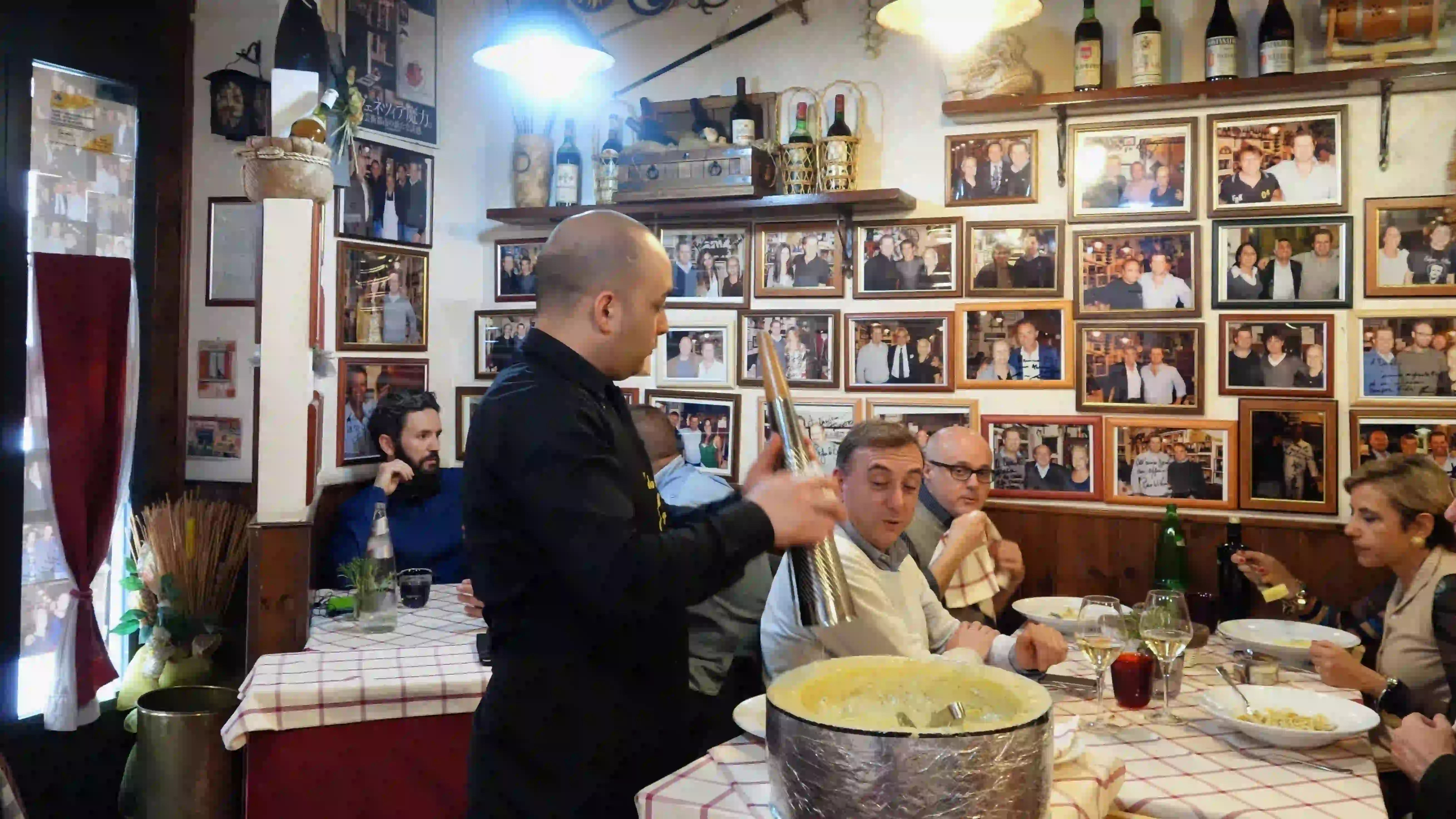da danilo - preparing cacio e pepe in a cheese wheel da danilo - preparing cacio e pepe in a cheese wheel