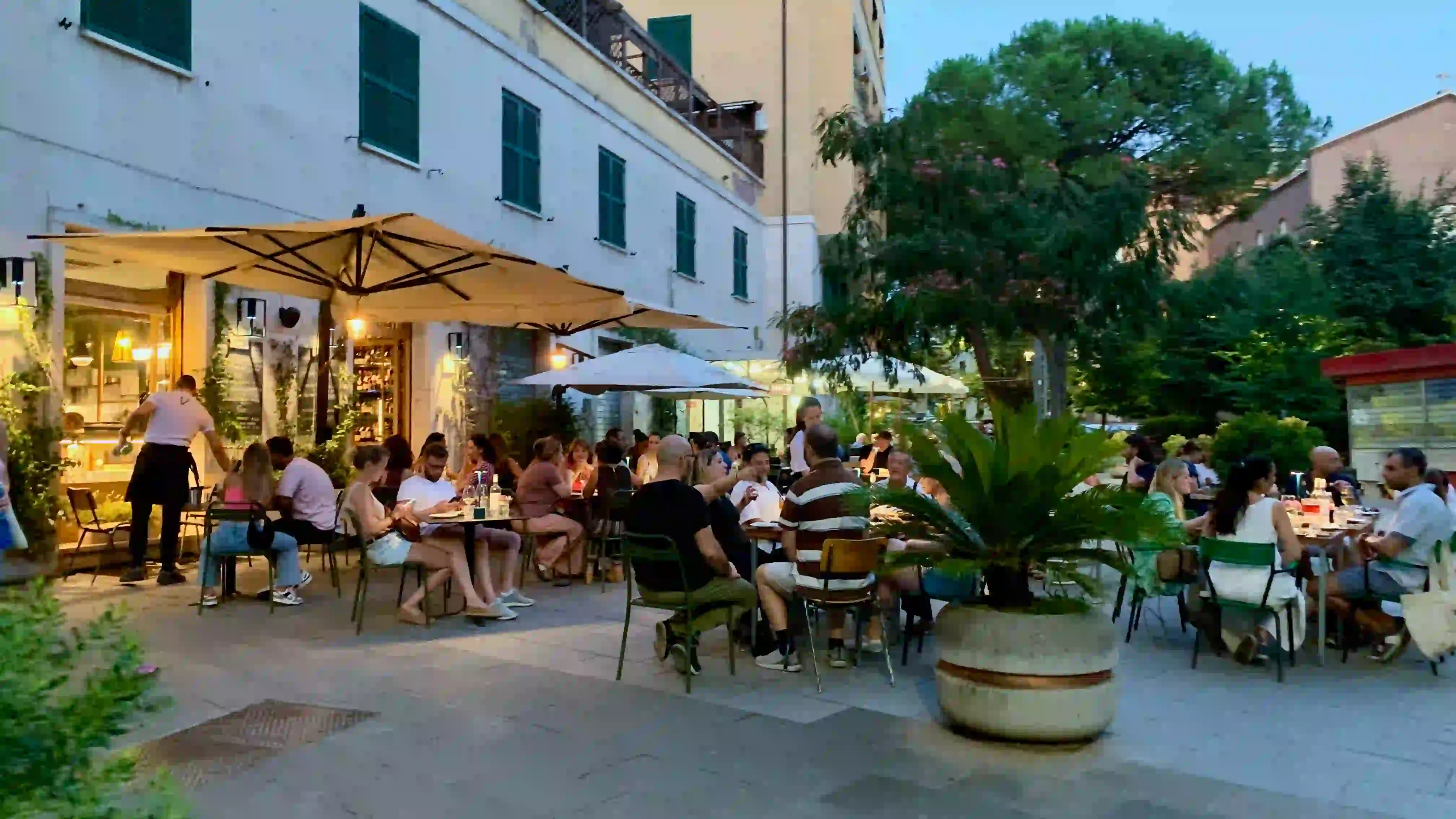 people enjoying outside aperitivo in august enoteca vicino with people outside