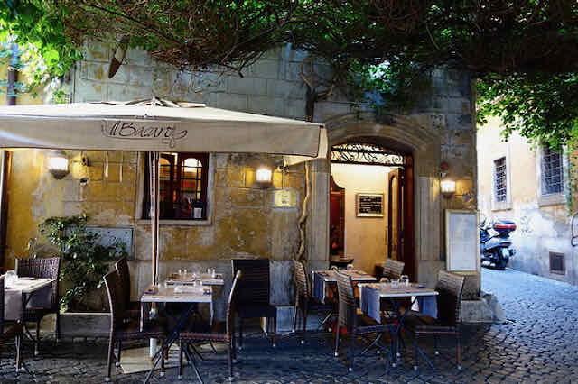 cozy romantic dining at il Bacaro in Rome ivy covered trellis at il bacaro in rome