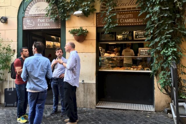 people eating la renella pizza outside