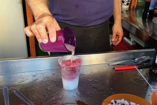 adding syrup to grattachecca