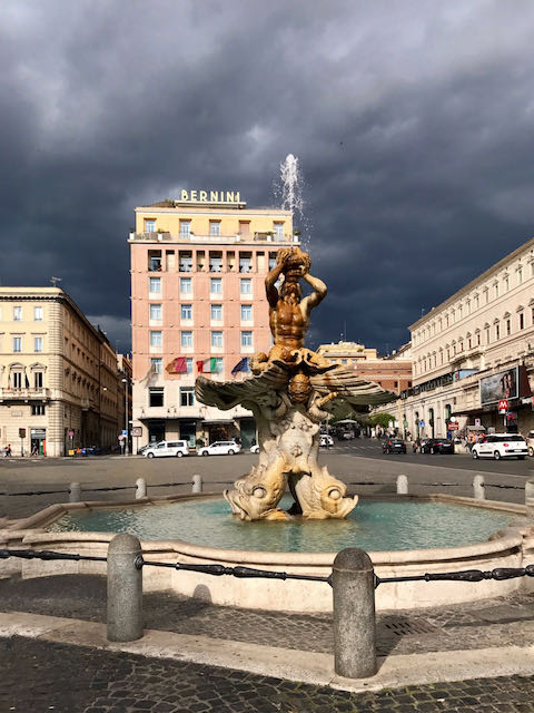 piazza barberini with sun and coulds piazza barberini before the storm