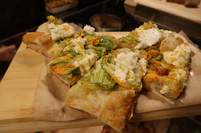 Pizza with zuccini flowers by the slice