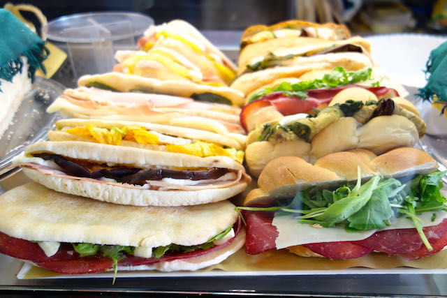 sandwiches on display at a bar in Rome
