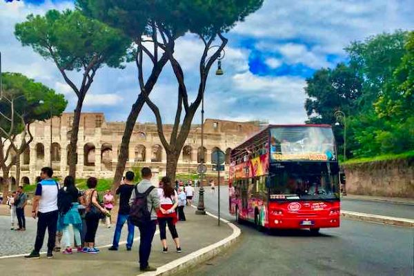 city sightseeing bus in front of Colosseum