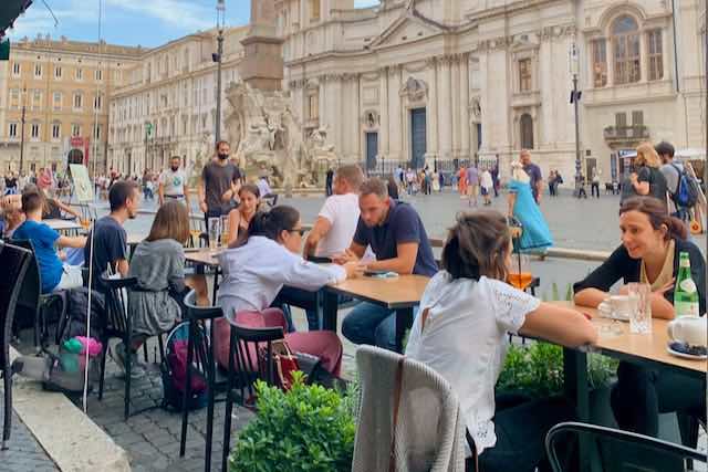 People enjoying mid-September mild weather in Piazza Navona how to dress in rome in mid-september