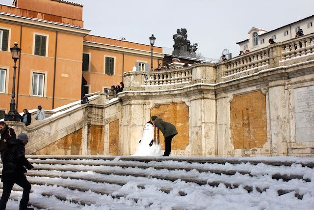 kissing a snowman at the spanish steps on a rare snow day in rome