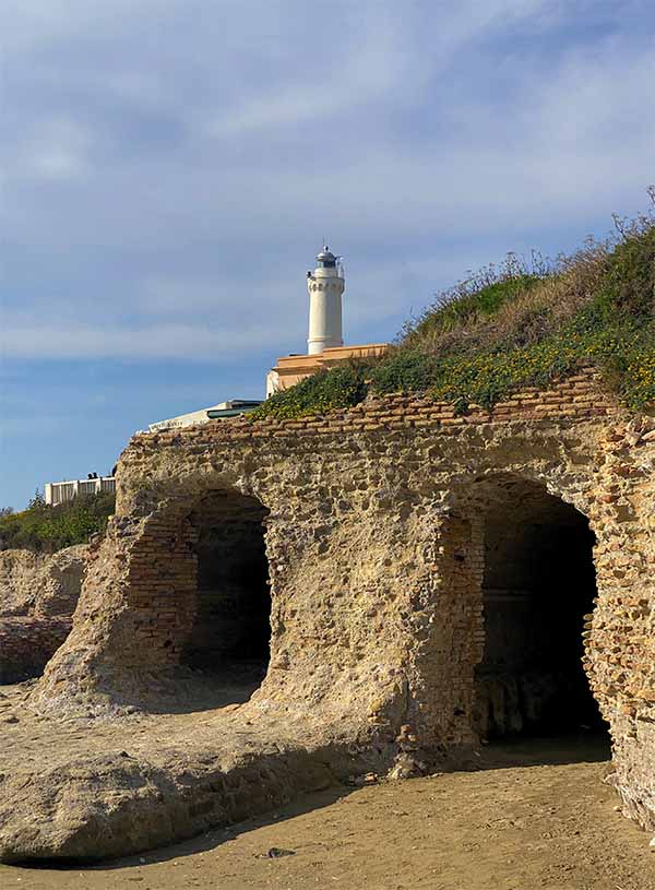 view of Anzio Lighthouse from the ruins of Nero's Villa Grotto on the beach